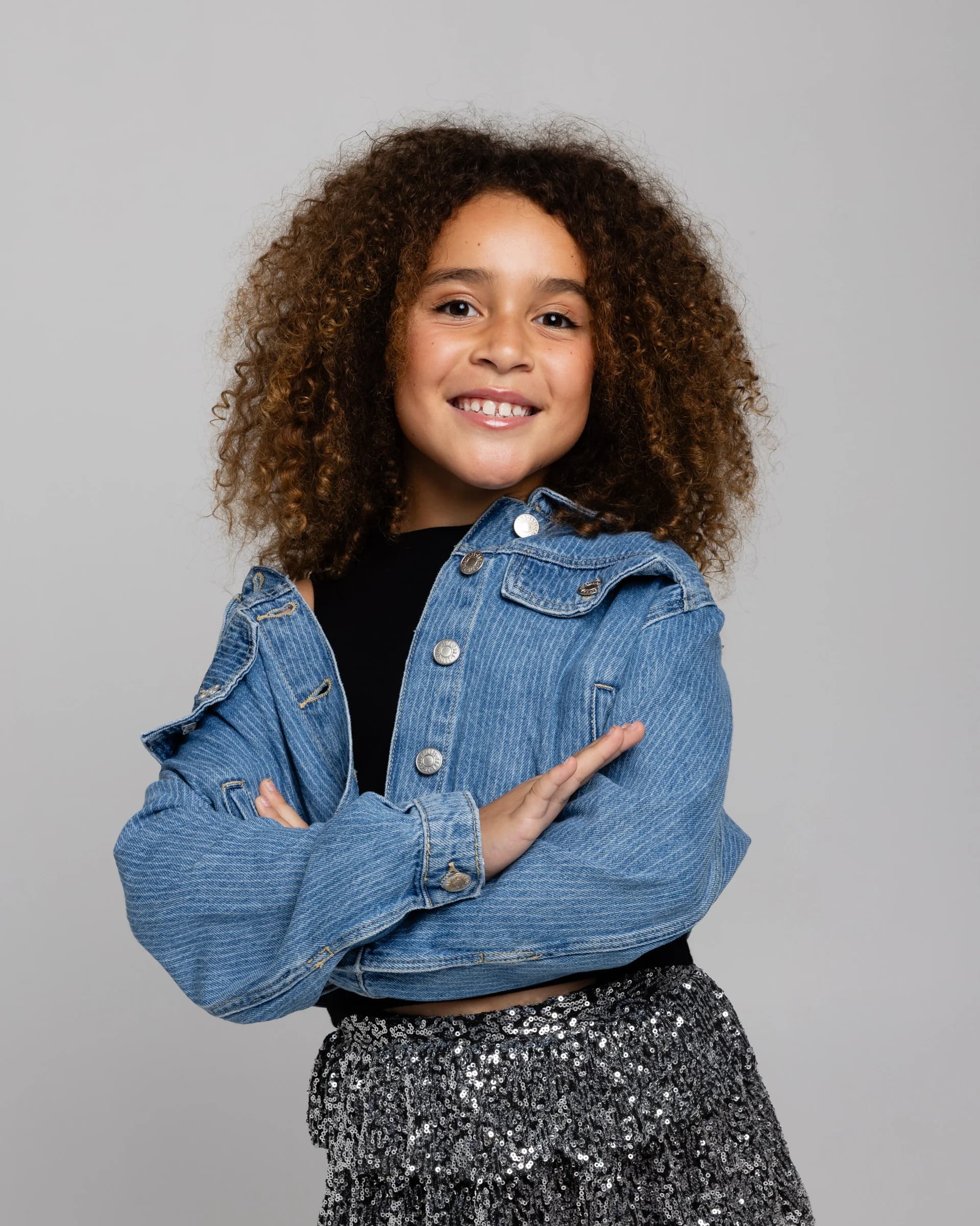 NVA young artist in a denim jacket smiling at the camera