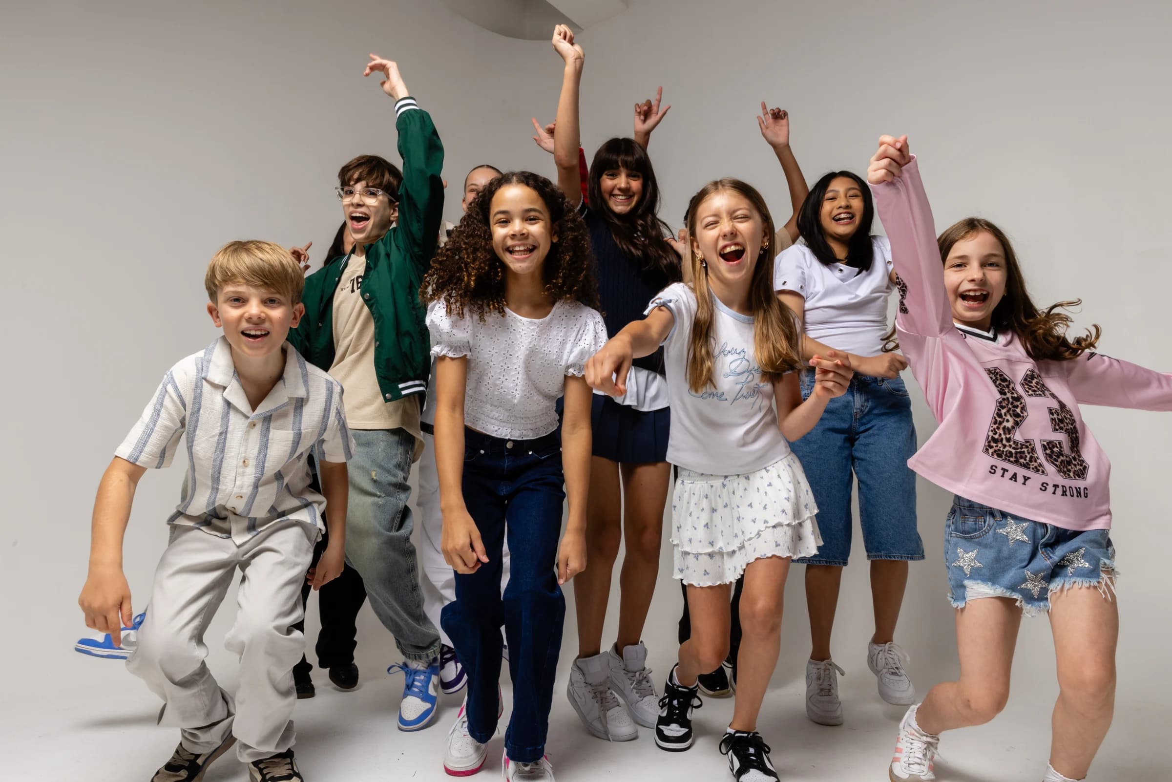 NVA young artists smiling and celebrating together in the studio